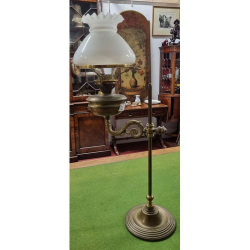 563 - A 19th Century Brass rise and fall Lamp with cloudy glass shade.