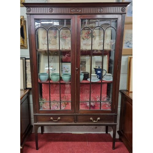 179 - A good Edwardian Mahogany two door Display Cabinet with twin frieze drawers on tapered supports. 106... 