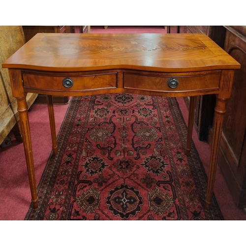 466 - A reproduction Mahogany and Veneered two drawer Side Table with serpentine concave front and reeded ... 