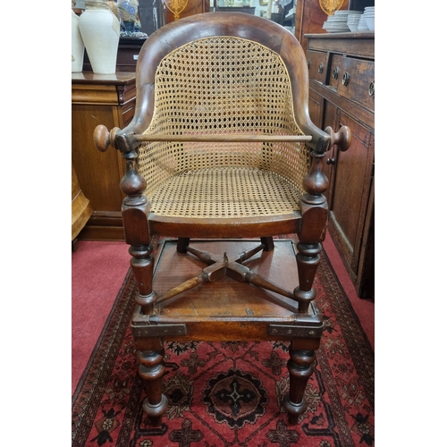 486 - A 19th Century Child's Chair on stand with canework seat.