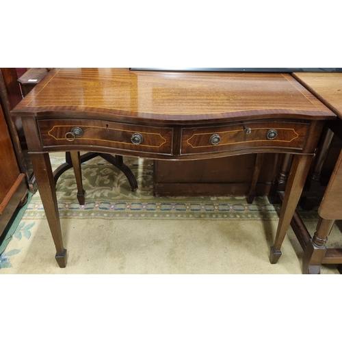 550 - A reproduction Mahogany and inlaid serpentine fronted Side Table with twin frieze drawer on square t... 