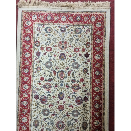 654 - A good ivory ground Runner with multi borders and unique repeating medallion design. 246 x 69 cm app... 