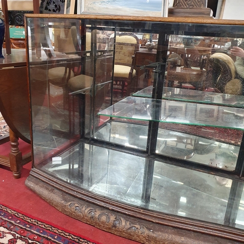 1077 - A 19th Century low shop Display with serpentine outline, with glass shelves. (glass cracked side).  ... 