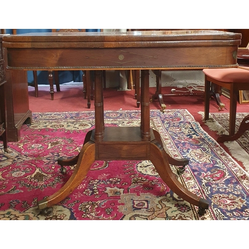 1118 - A fantastic early Regency Rosewood and brass inlaid fold over Card Table on turned reeded supports a... 