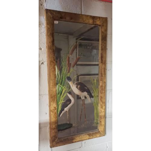 651A - A Rectangular Mirror with painted images of Herons in a Velure covered wood frame
H 92 x W 45 cm app... 