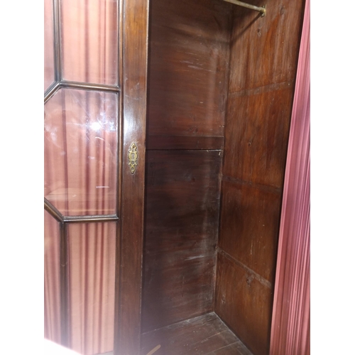 1182 - An extremely large 19th Century Mahogany two door Wardrobe with astragal glazed doors on bracket fee... 