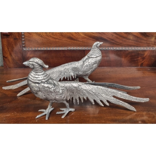 397 - A nice pair of Silver plate Pheasants.
H 13 x L 26 cm approx.