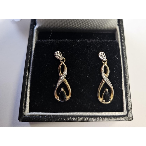 340 - A pair of Diamond and Sapphire Earrings.