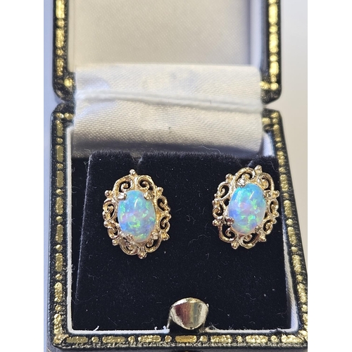 370 - A nice pair of Gold and Opal set Earrings.