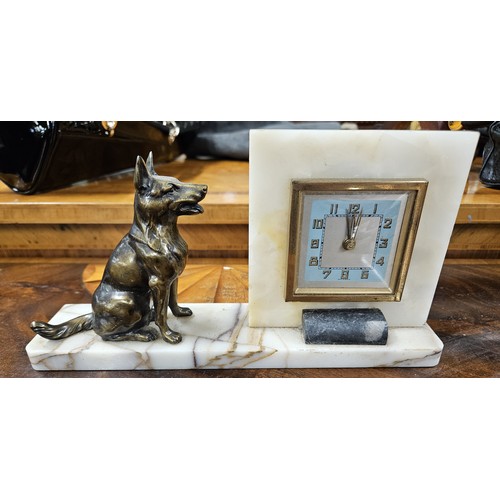 689 - A mid 20th Century Clock with alabaster outline depicting a bronze german shepherd on a platform pli... 