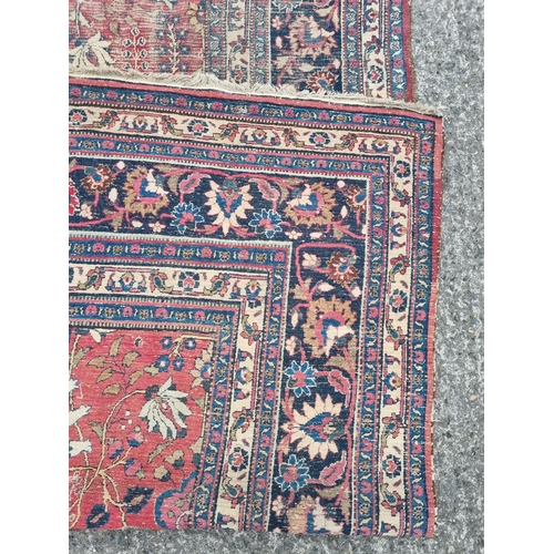 1277 - A large well worn Persian Burgundy ground Carpet with unique medallion design, 410 x 260 cm approx.