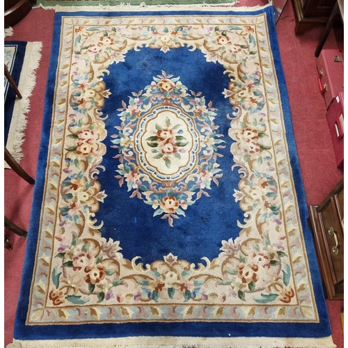 559 - A Chinese blue ground Carpet with central medallion design and multi borders. 215 x 140 cm approx.