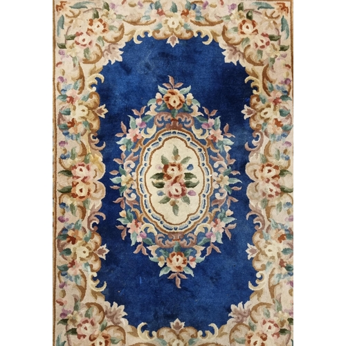 559 - A Chinese blue ground Carpet with central medallion design and multi borders. 215 x 140 cm approx.