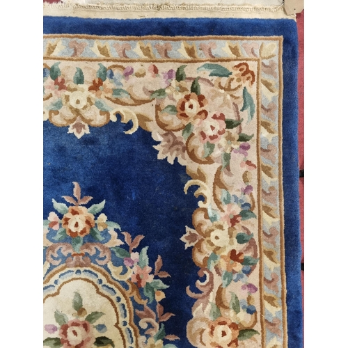 559 - A Chinese blue ground Carpet with central medallion design and multi borders. 215 x 140 cm approx.