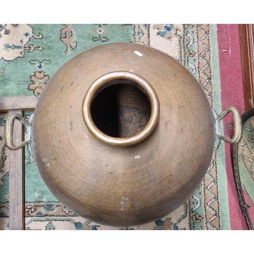 167 - An extremely large Copper bulbous Urn with panel beaten outline and twin lifting handles. H 71 cm ap... 