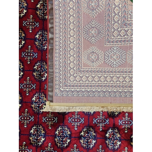 600A - A red ground Turkish Soft Full Pile Carpet with central repeated panel design surrounded by borders ... 