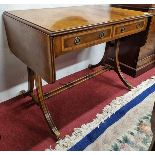 596 - A good early 20th Century Mahogany and Veneered Sofa Table on square supports and stretcher base wit... 