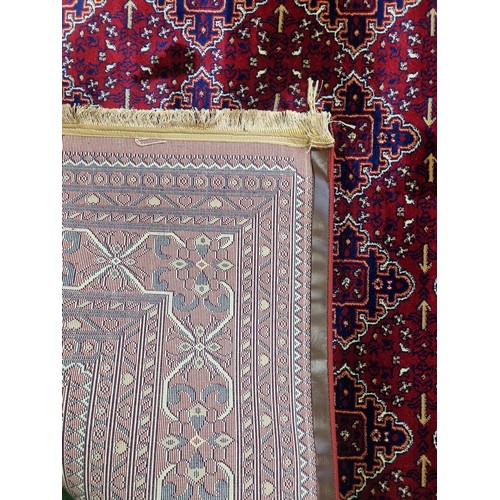 700A - A red ground Turkish Soft Full  Pile Carpet with central medallion design surrounded by borders and ... 