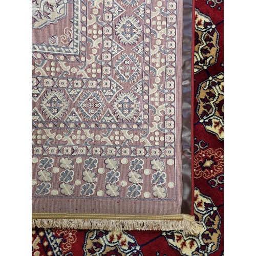 900B - A red ground Turkish Soft Full  Pile Carpet with central medallion design surrounded by borders and ... 