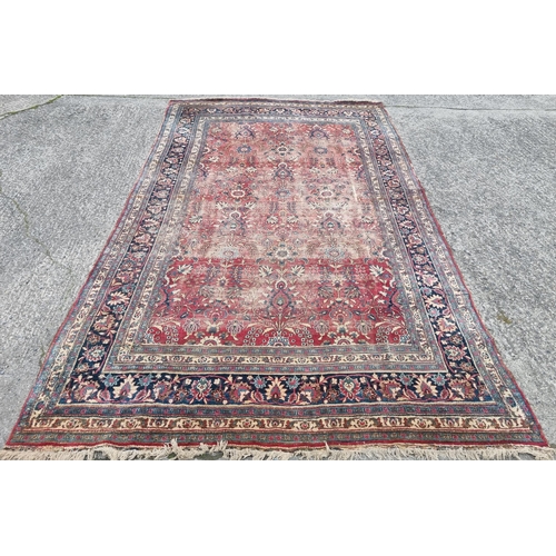 1277 - A large well worn Persian Burgundy ground Carpet with unique medallion design, 410 x 260 cm approx.