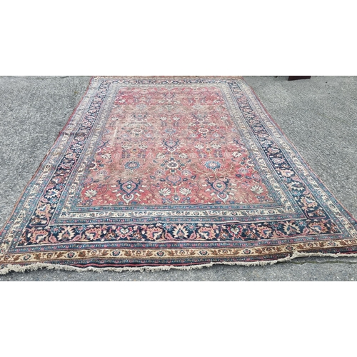 1277 - A large well worn Persian Burgundy ground Carpet with unique medallion design, 410 x 260 cm approx.