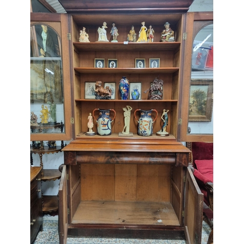 44 - Of very good quality. A 19th Century Mahogany two door Bookcase with highly carved panel base and ar... 