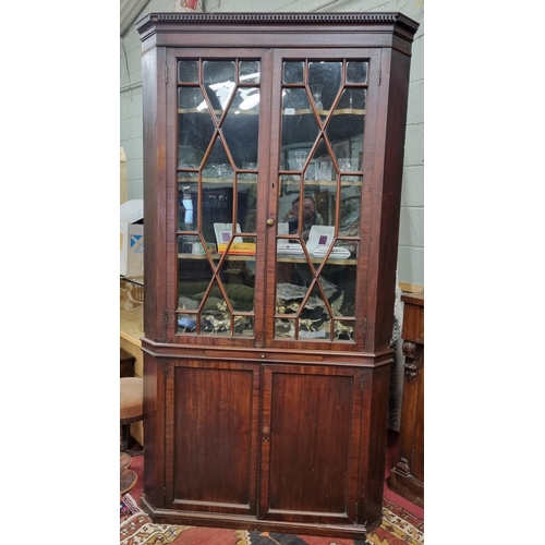 61 - A 19th Century Mahogany two door corner Cabinet with brushing slide centre and twin panel base and g... 