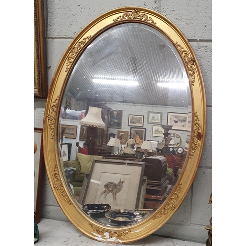 95 - A really good 19th Century oval bevelled Mirror with highly moulded outline. (damage to left part of... 