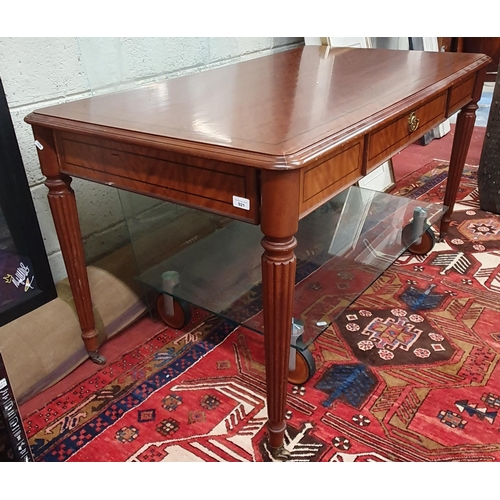 921 - A good Mahogany rectangular desk with single drawer frieze on turned reeded supports and glass top. ... 