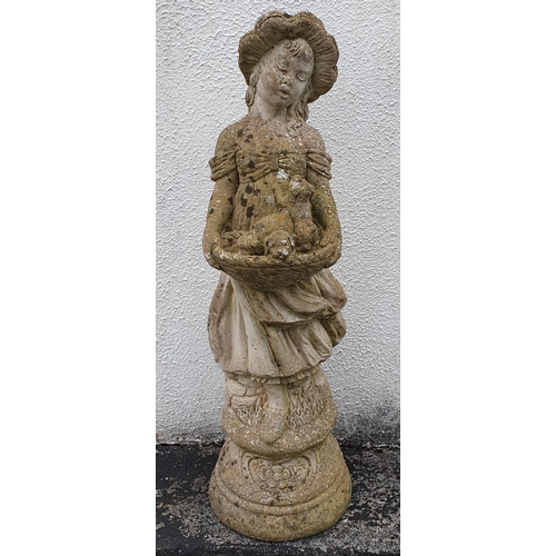 943 - A Reconstituted Stone Garden Statue of a Girl holding Puppies. Height 70 cm approx.