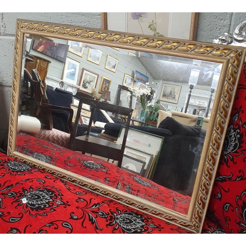 940 - A modern Gilt Mirror with bevelled mirror glass. 86 x 61 cm approx.