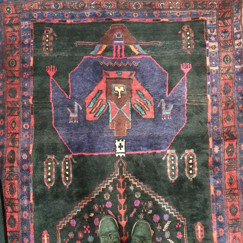 937 - A Persian blue ground Rug with multi borders and unique central medallion design. 305 x 138 cm appro... 