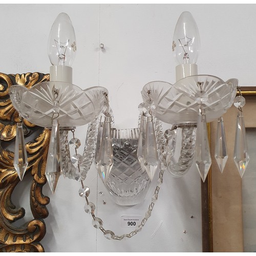 900 - A pair of wall mounted twin branch Candelabra with crystal drops. 1 lacking lower globe.