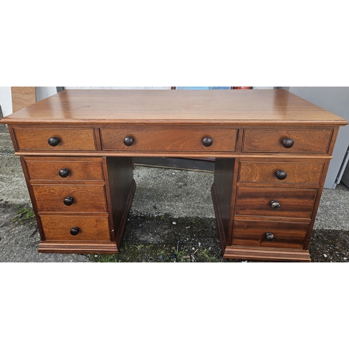 1023 - A very heavy Mahogany veneered Desk with three drawer frieze over three graduated drawers.