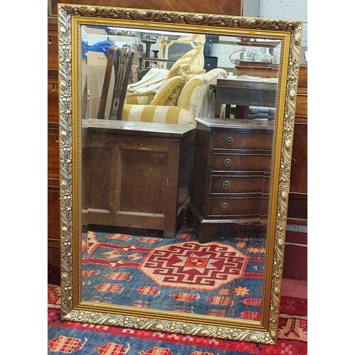 98 - A modern Gilt rectangular Mirror with bevelled mirror glass. 71 x 102 cm approx.