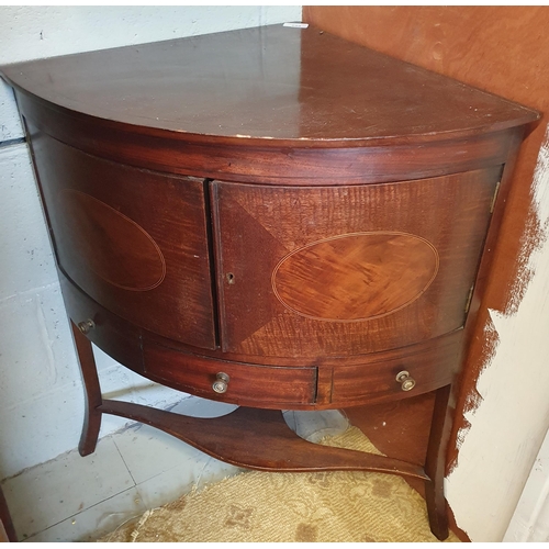 100 - An Edwardian Mahogany two door Corner Unit with twin panel elliptical doors over a single drawer bas... 