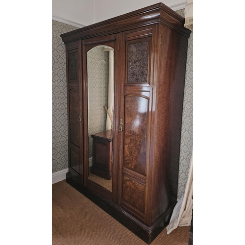 157 - A good Walnut and Burr Walnut three door Wardrobe with central bevelled mirror glass door flanked by... 