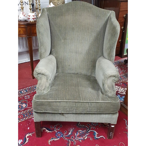 163 - An oversized Wingback Chair in the Georgian style upholstered in green stripe fabric.
B H 104 x W 78... 