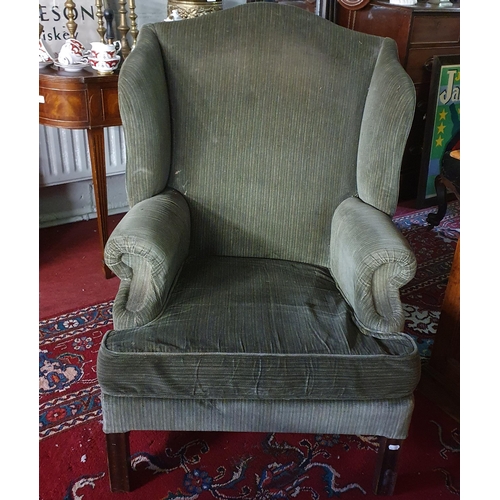 163 - An oversized Wingback Chair in the Georgian style upholstered in green stripe fabric.
B H 104 x W 78... 