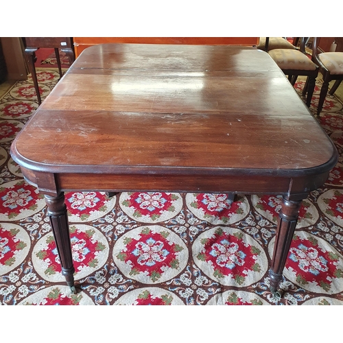 186 - An early 19th Century Mahogany dining Table with central scissor movement rails on turned reeded sup... 