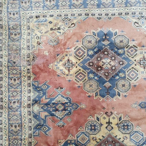 211 - A pink ground Carpet with multi borders and unique central medallion design. 285 x 193 cm approx.