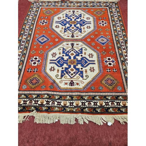 449 - A good Kazak cream ground Carpet with multi borders and central medallion design, 308cm x 254cm appr... 