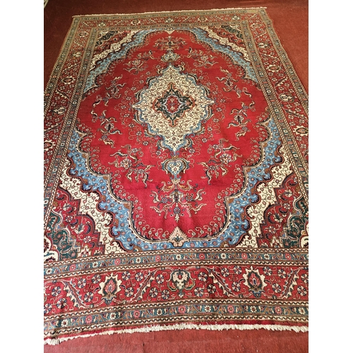 467 - An extremely large Persian red ground Carpet profusely decorated with blue and greens with multi bor... 