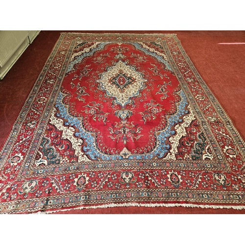 467 - An extremely large Persian red ground Carpet profusely decorated with blue and greens with multi bor... 