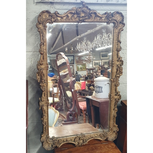 484 - A 19th Century Plaster gilt rectangular Mirror with highly carved and moulded outline. H 85 x W 52 c... 