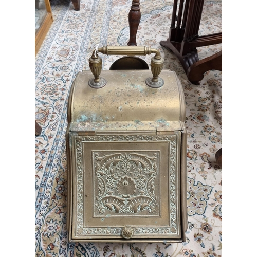 519 - A 19th Century Brass coal Skuttle with highly embossed lid and original shovel. W 26 x H 44 cm appro... 