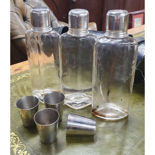 531 - A cased Vintage liquor set consisting of three shaped bottles with silver plated screw tops and shot... 