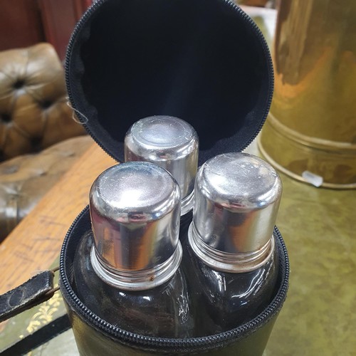 531 - A cased Vintage liquor set consisting of three shaped bottles with silver plated screw tops and shot... 