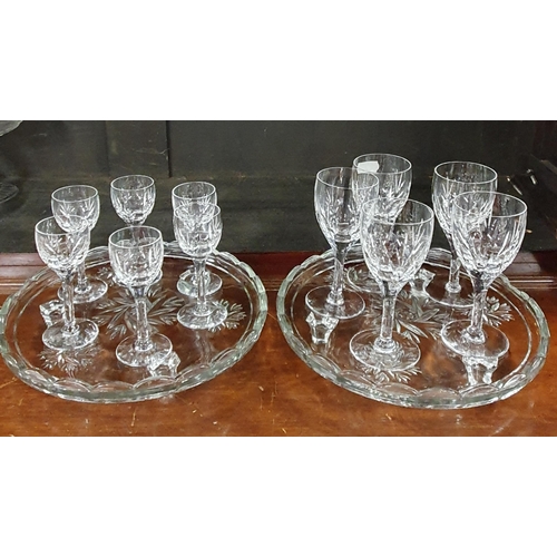 204 - A good quantity of Crystal and Glass to include port glasses, centre dishes on one shelf.