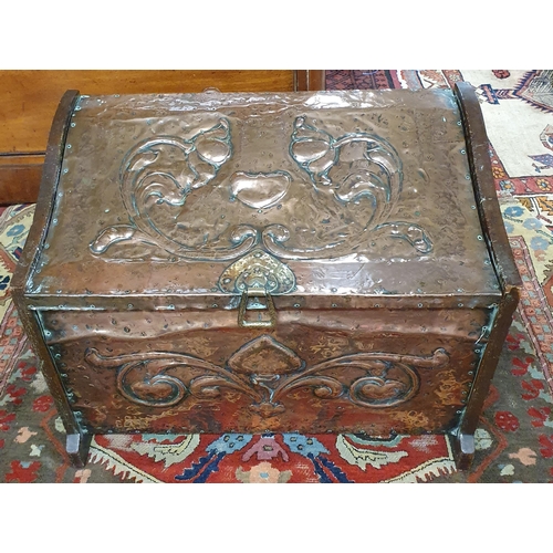 455 - An Art Noveau Copper and timber panel beaten coal Box with lifting handles. W 60 x H 45 cm approx.